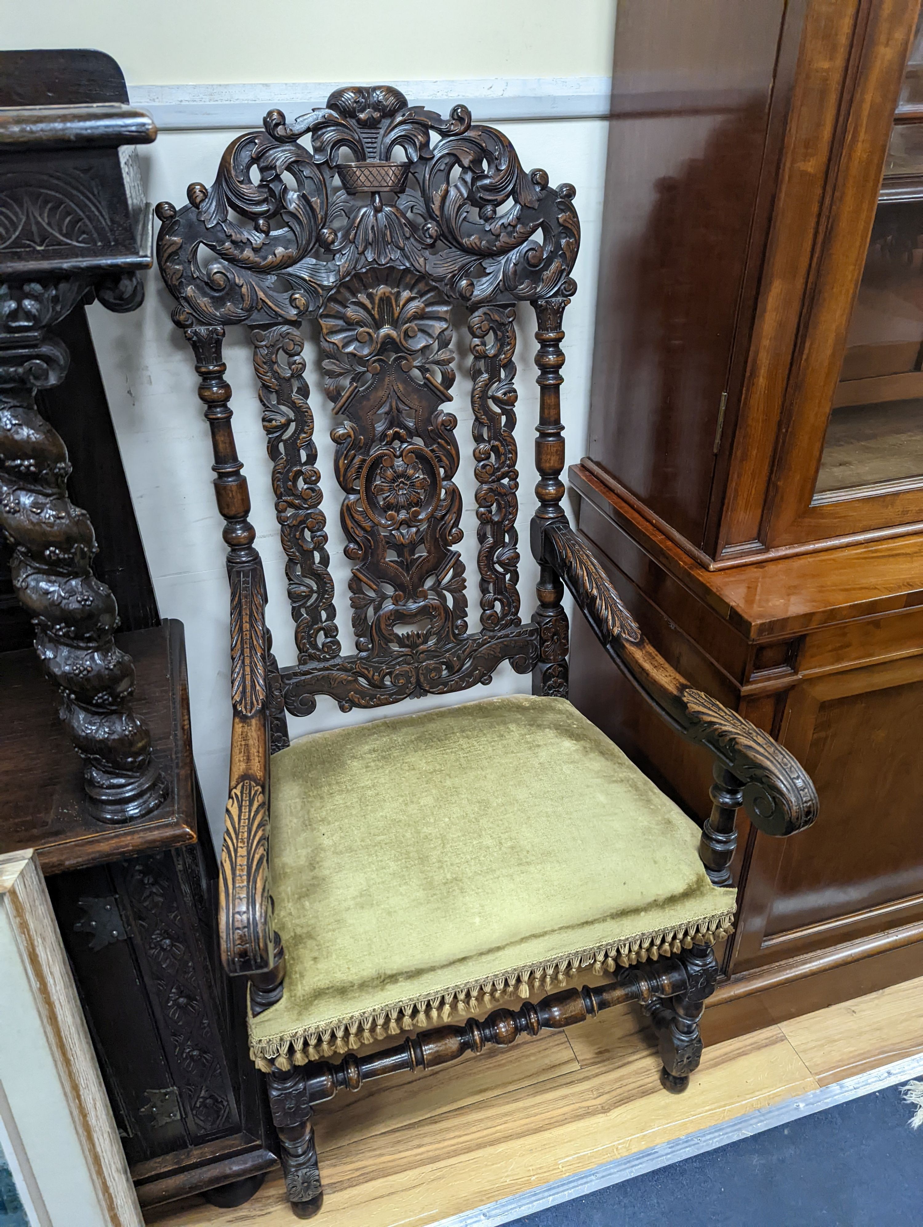 A pair Charles II style carved oak elbow chairs with upholstered seats on turned underframes, width 63cm, depth 54cm, height 133cm